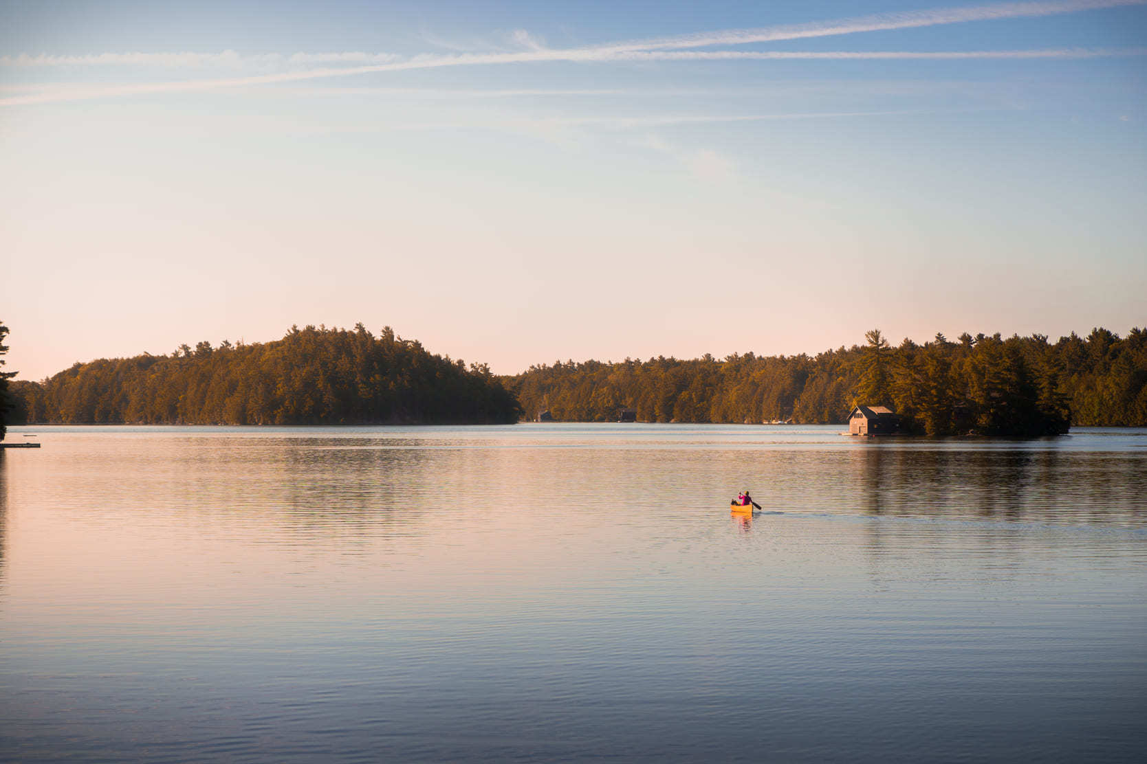 An aerial view of canoeing on a Muskoka, Ontario lake.